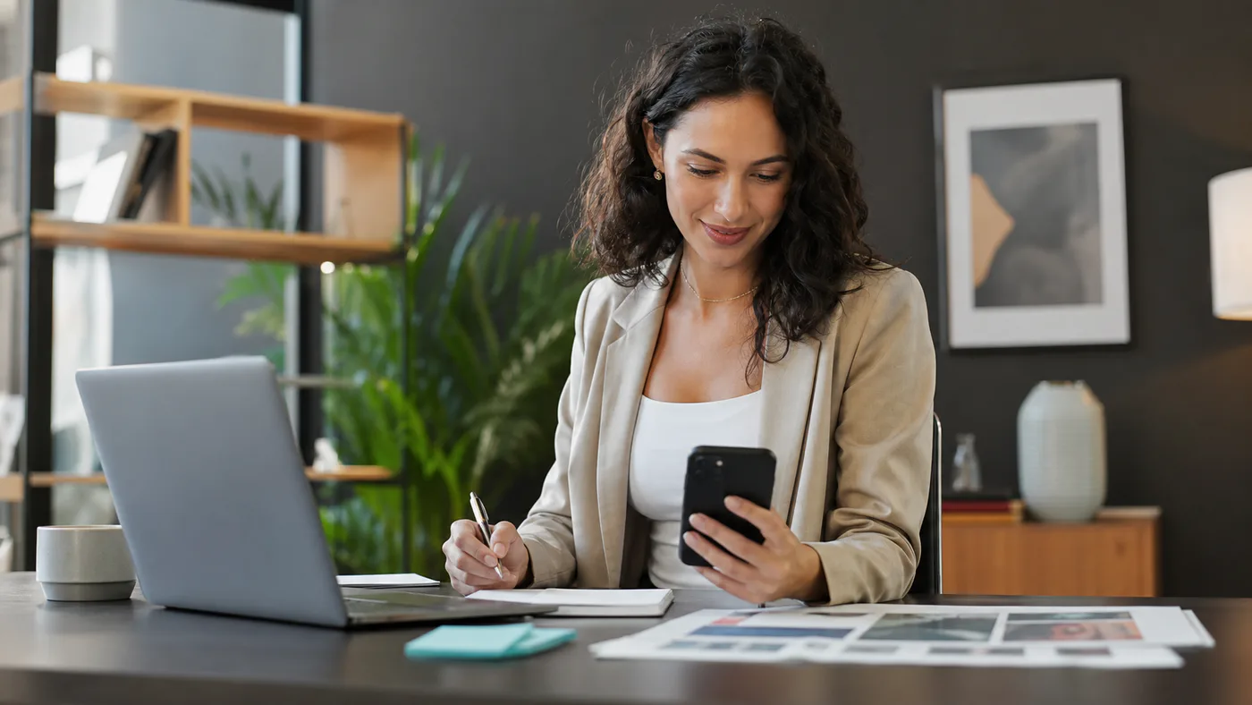 Small business owner planning content and outreach on a laptop and phone